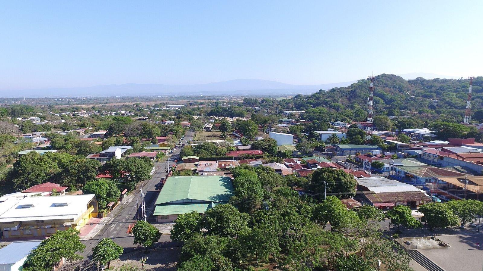 Aerial view of the town of Ciudad Colón in Mora, Costa Rica, with hills behind.