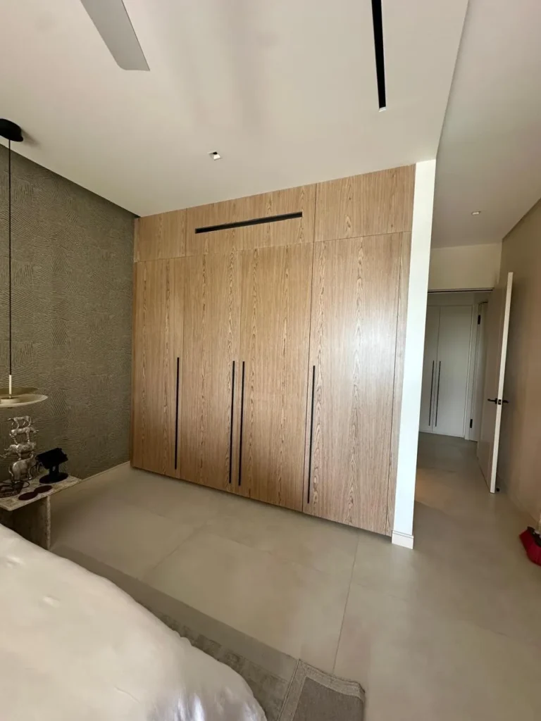 Full-height oak wardrobe wall in a bedroom renovation