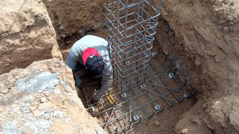 Reinforcing steel cage set in a deep footing during foundation work.