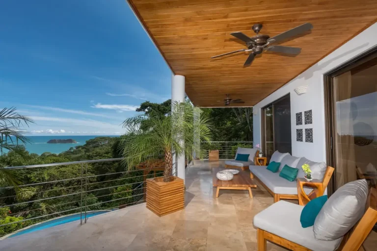 Open living area with wood ceilings that opens to a terrace above the ocean.