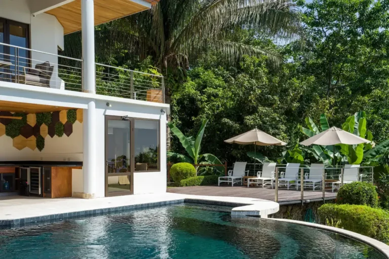 Free-form pool beneath the villa's terraces and tropical gardens.