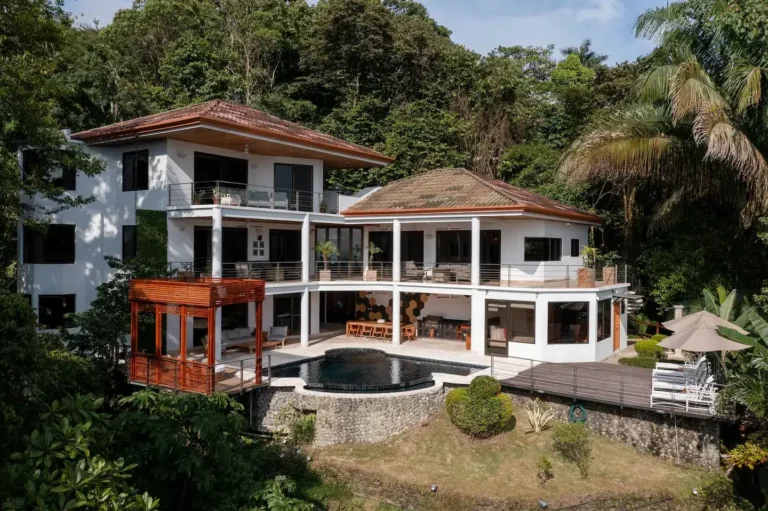 Villa perched on a jungle hillside with terraces stepping down to the pool.