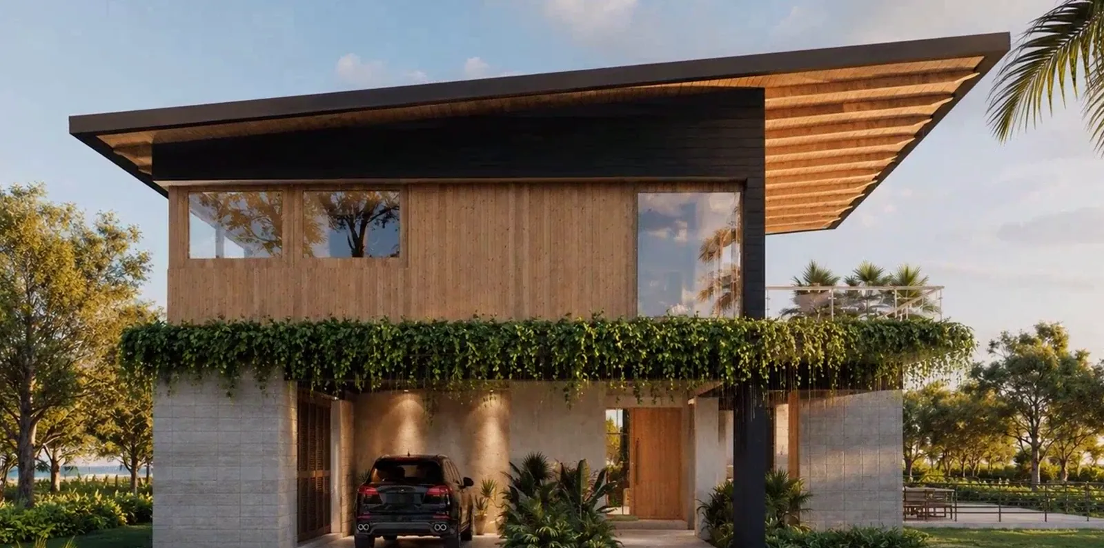 Front facade of the Nosara residence: a timber and stone volume under a deep sloped roof, with planting along the terrace