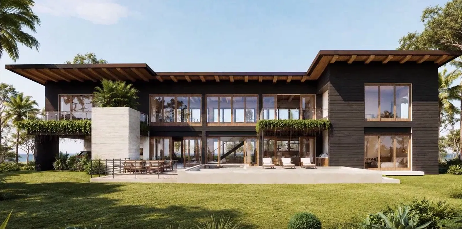 Our architect’s design for a family home in Nosara, with sloped wood roofs and tall windows over the garden