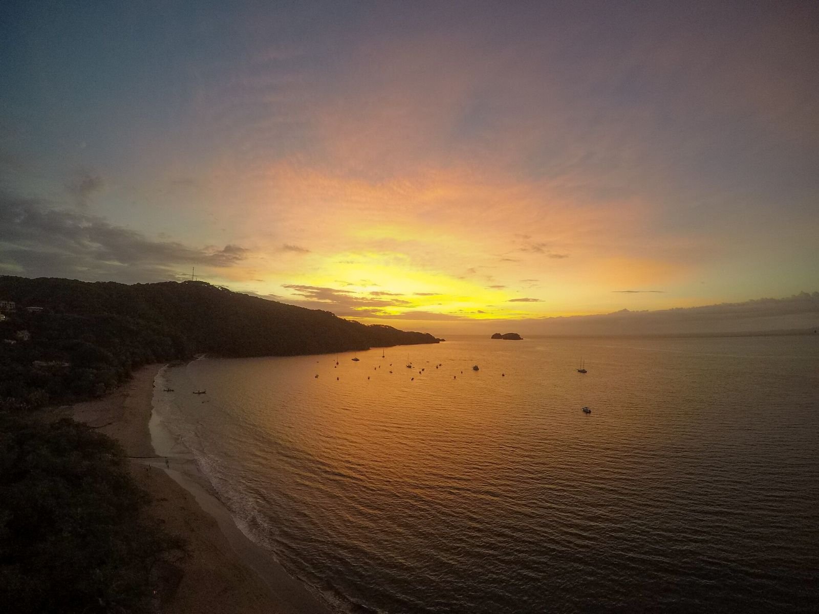 Golden sunset over the bay at Playa Hermosa in Guanacaste, Costa Rica.