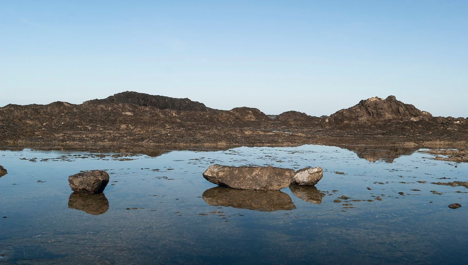 Rocks reflected in still tide water at Playa Junquillal, Guanacaste, just after dawn.
