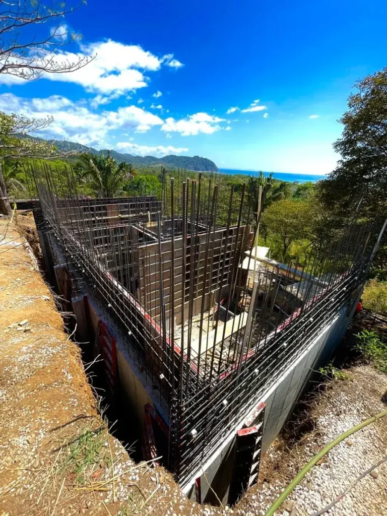 A home under construction on a hillside lot with ocean views