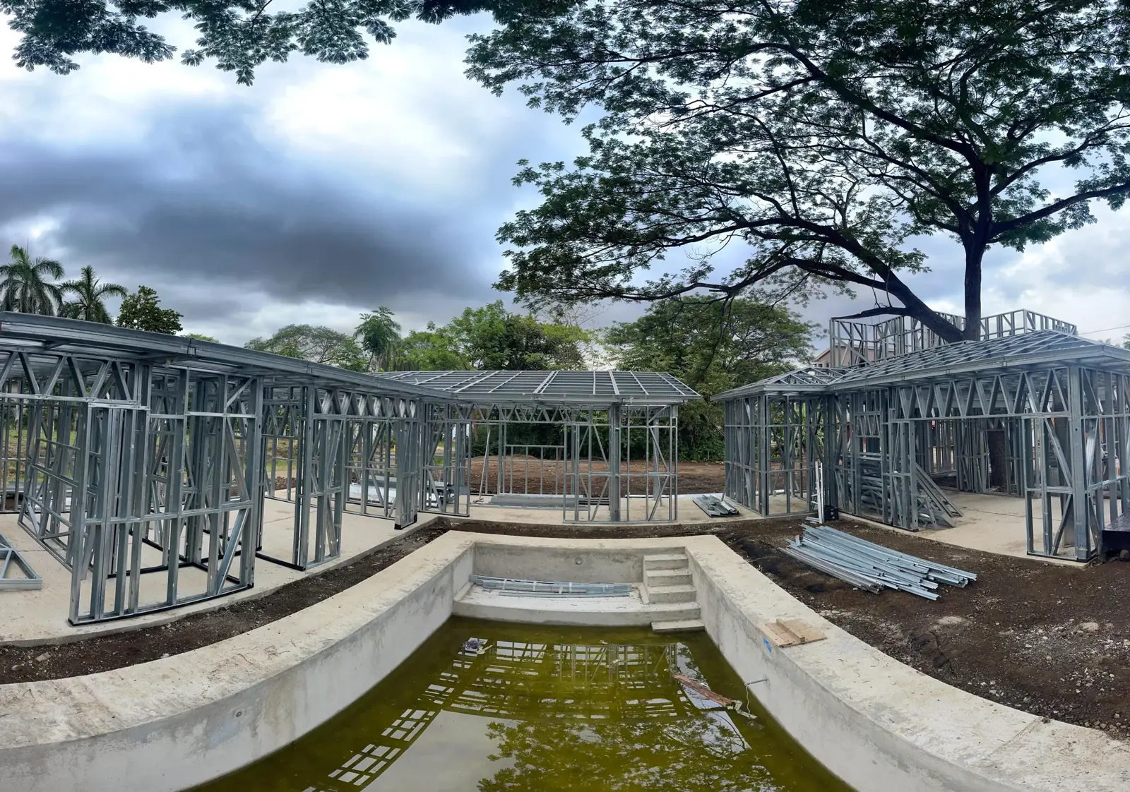 Pool Construction 12 Steel-framed walls rising around a courtyard pool shell during construction.