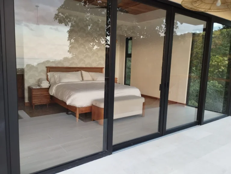 Bedroom seen through floor-to-ceiling sliding glass, Villa Pochote