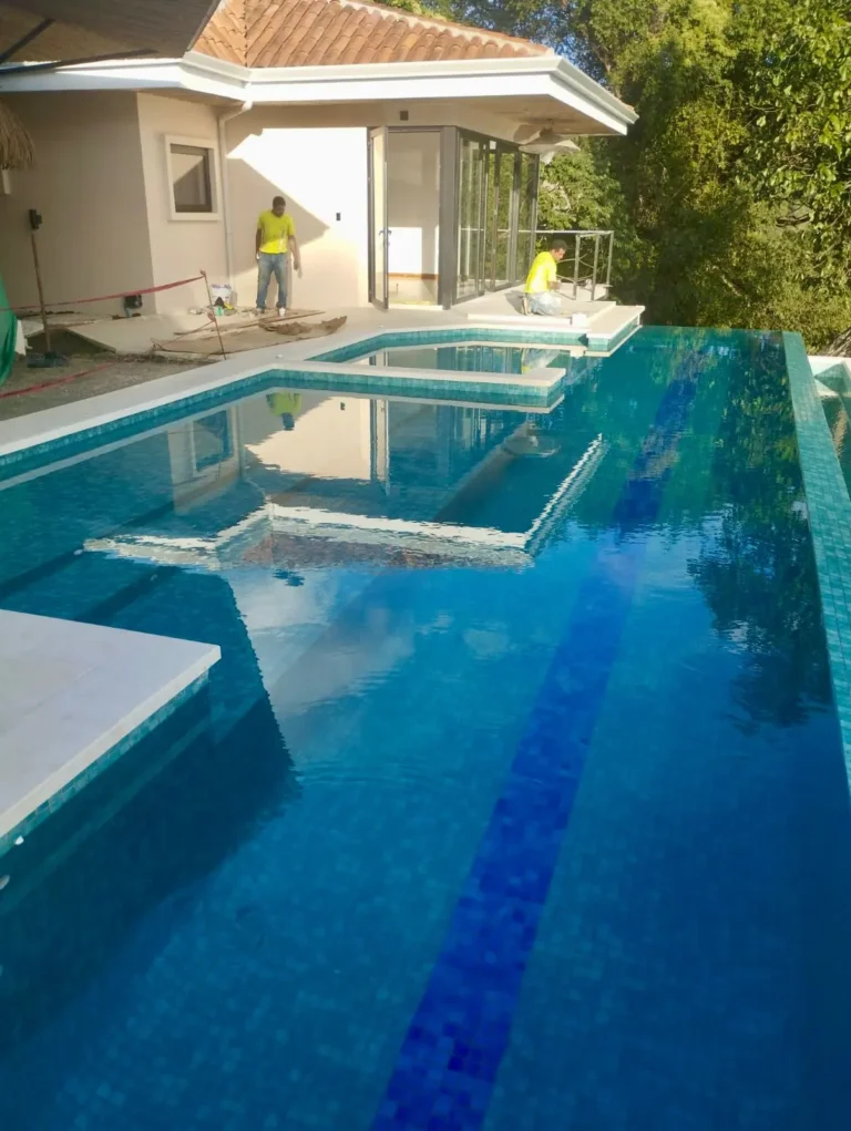 Pool at Villa Pochote with a dark tile lane and the terrace beyond